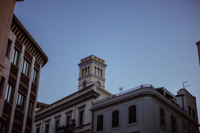 Low angle view of building against clear blue sky