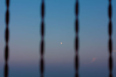 Close-up of barbed wire against sky at dusk