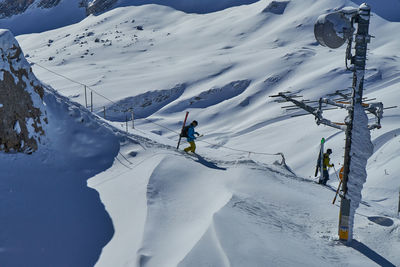 People skiing on snowcapped mountain