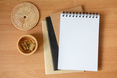 Directly above shot of note pad and book on table