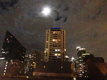 Low angle view of illuminated skyscraper against sky at night