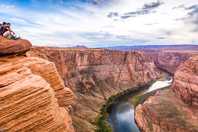 Scenic view of rock formations against cloudy sky