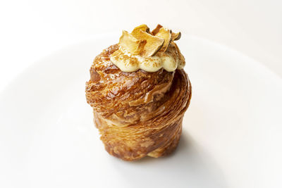 Close-up of dessert in plate against white background