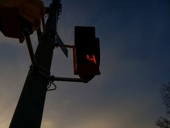 Low angle view of illuminated street light against sky