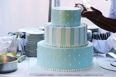 Midsection of man preparing cake