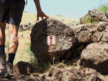 Low section of man standing on rock