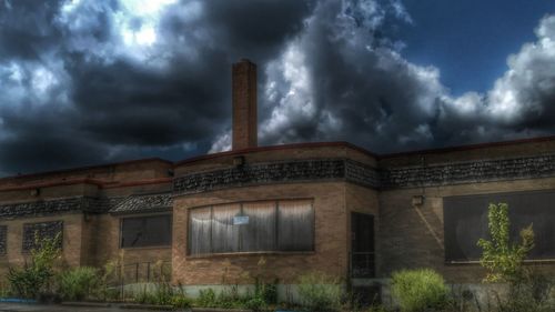 View of factory against cloudy sky