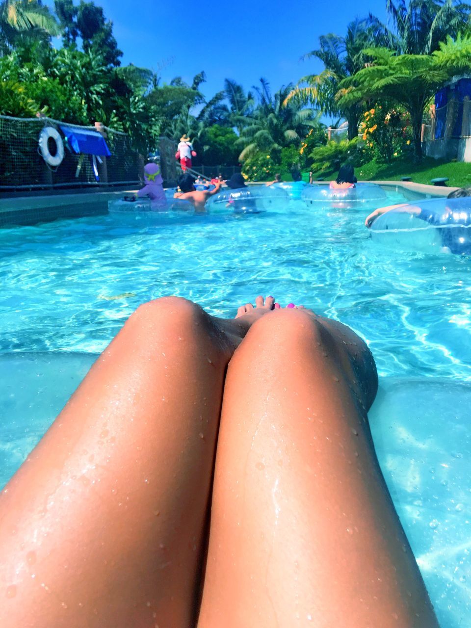 LOW SECTION OF PEOPLE SWIMMING IN POOL