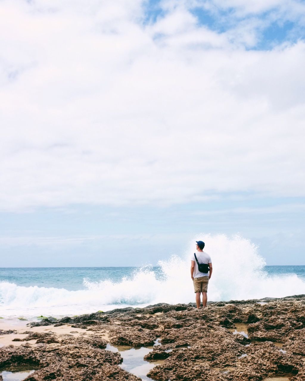 sea, horizon over water, water, sky, tranquil scene, tranquility, cloud - sky, scenics, one person, beauty in nature, nature, lighthouse, rock - object, cloud, shore, beach, guidance, protection, cloudy, idyllic