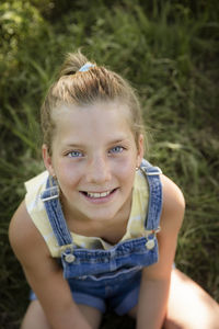 Portrait of cute girl sitting outdoors