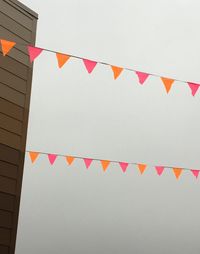 Low angle view of flags against sky