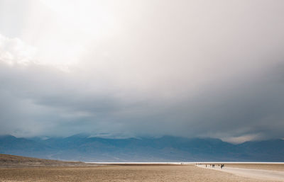 Scenic view of desert against cloudy sky at death valley national park