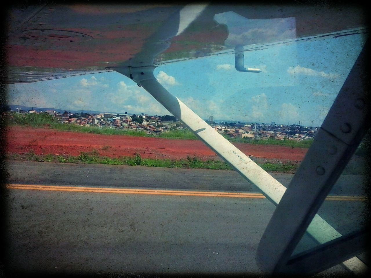 window, glass - material, transparent, transfer print, indoors, architecture, built structure, sky, water, auto post production filter, transportation, road, glass, reflection, building exterior, day, wet, no people, vehicle interior, looking through window