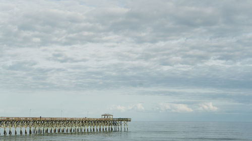 Pier over sea against sky