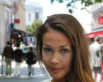 Close-up portrait of young woman in city