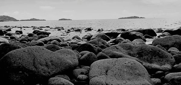 Rocks on beach against sky