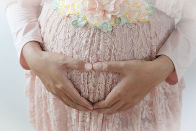 Midsection of woman holding hands