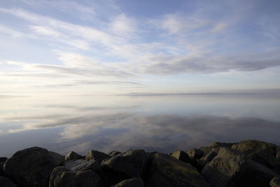 Scenic view of rocks in sea against sky