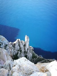 High angle view of rocks by sea