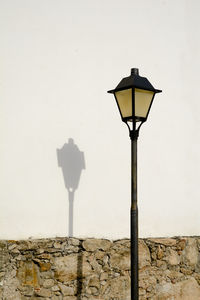 Low angle view of street light against sky
