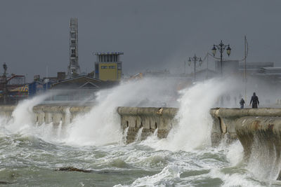 Waves crash against the seawall and promenade at southsea,  portsmouth, uk