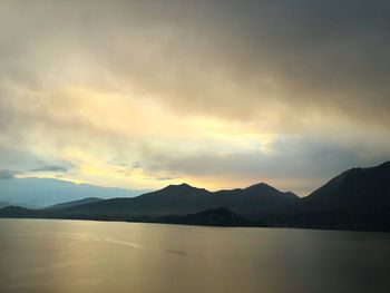 Scenic view of lake against sky during sunset