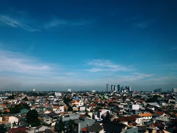 High angle view of townscape against blue sky