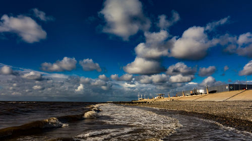 Scenic view of beach against blue sky