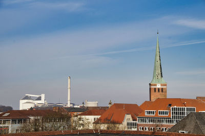 Skyline of uelzen with sugar factory and church tower against sky