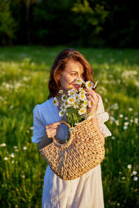 Close-up of girl blowing flowers