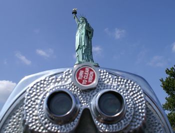 Coin-operated binoculars against statue of liberty