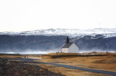 Curch on snowcapped mountain against sky