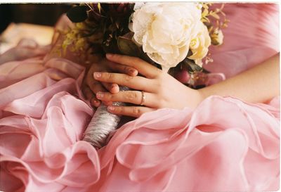 Woman holding bunch of flowers