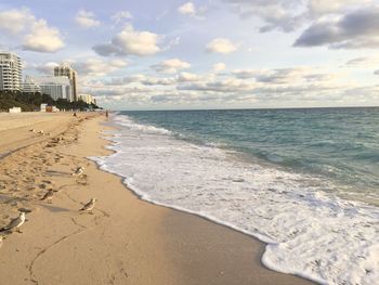 Scenic view of sandy beach against sky