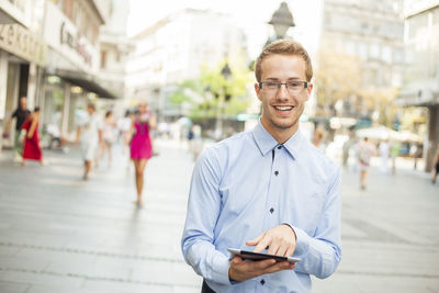 Portrait of young man standing outdoors
