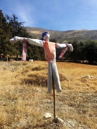 Man with umbrella against sky