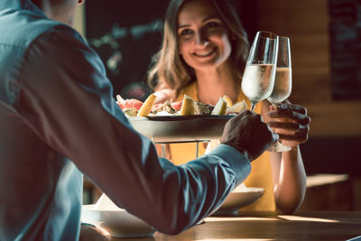 Couple drinking wine on table in restaurant