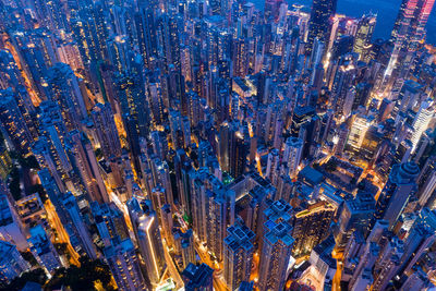 High angle view of city lit up at night