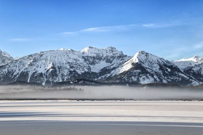 Scenic view of snowcapped mountains against sky