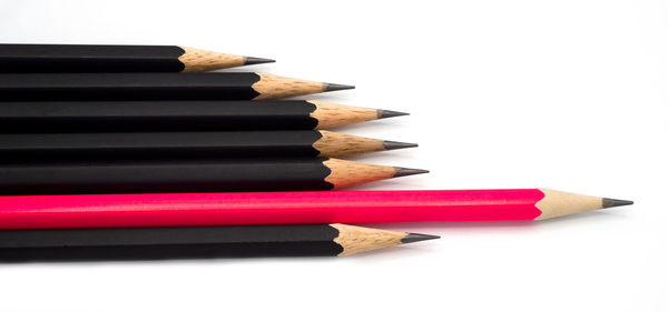 Close-up of colored pencils against white background