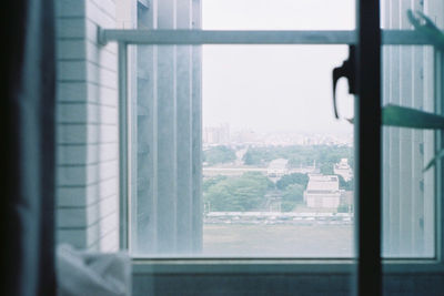 Close-up of glass window against building