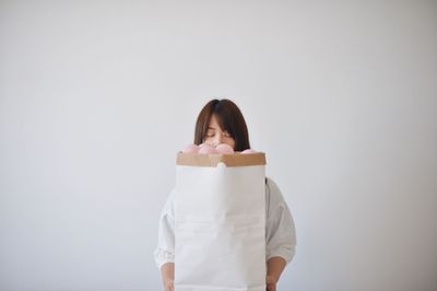 Portrait of a smiling young woman over white background