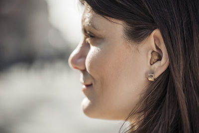 Young woman with hearing aid, close-up