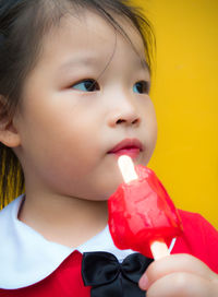 Close-up portrait of cute girl looking away