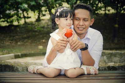 Girl with father holding toy