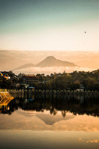 Scenic view of lake against sky during sunrise