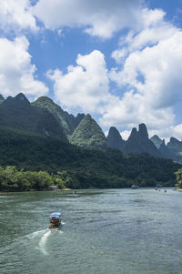 Scenic view of boat on mountain against sky