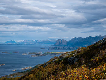 Scenic view of sea and mountains against sky
