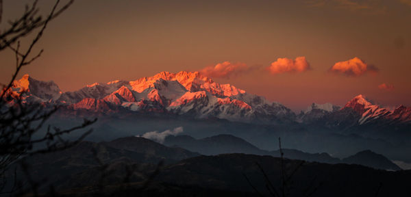 Scenic view of snowcapped mountains against sky during sunset