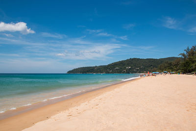 Scenic view of beach against blue sky